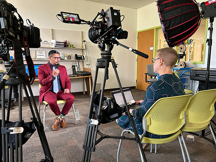 Rhode Island State Representative David Morales records an interview with ALA President Emily Drabinski at Cranston Public Library.