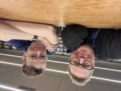 Emily Drabinski and Tom Bober, MASL President and librarian at Captain Elementary School, pose with smiles in a school library/