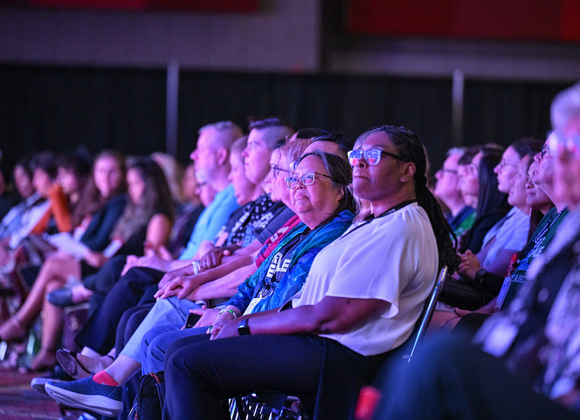 A group of people seated at a conference enjoying the panel