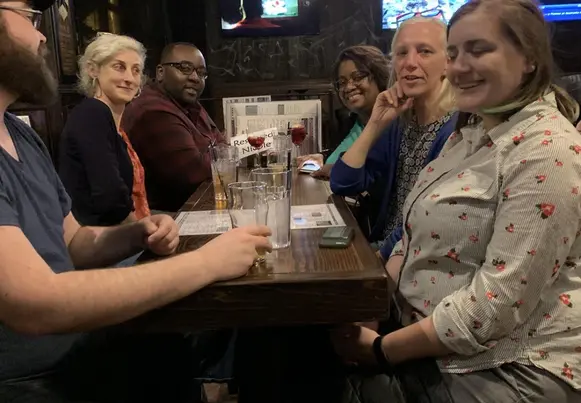 A gathering of trainers meeting at the pub after work.