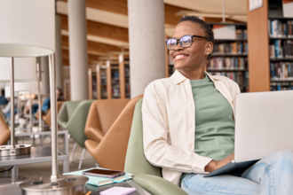 A woman learning on her laptop in the library