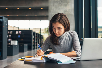 A photo of a woman working in a library