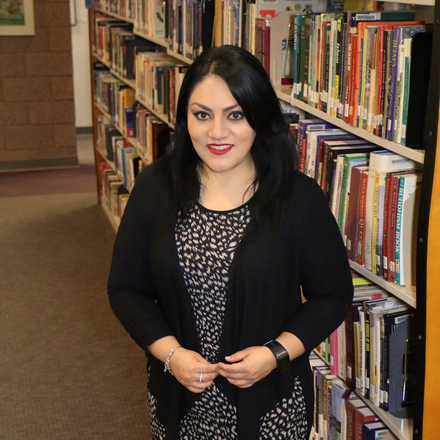 Lorely Ambriz at the EPCC Northwest Campus Library by the library stacks