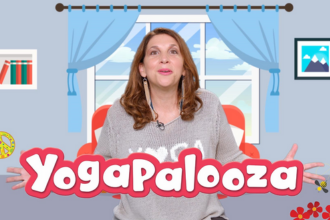 Bari Koral, a popular children's recording artist and a globally recognized kids’ yoga educator, in front of a cartoon wall with draped window, overlaid with text: Yagopalooza.